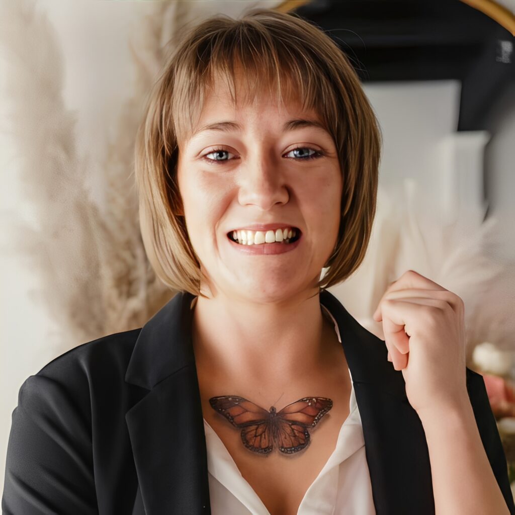 Smiling person with butterfly tattoo